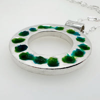 Statement-silver-enamel-circle-pendant-on-a-white-background