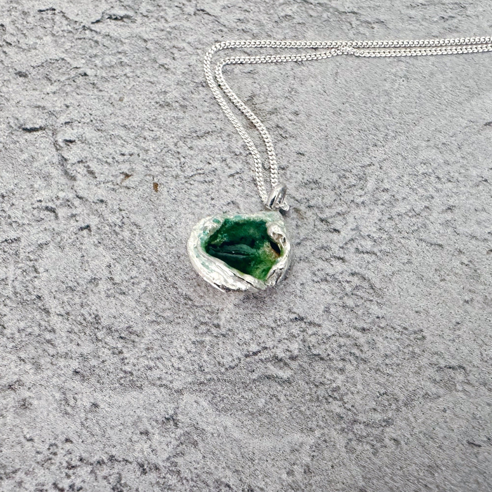 Handmade molten sterling silver pendant with organic texture on an 18-inch chain, photographed on a plain background.