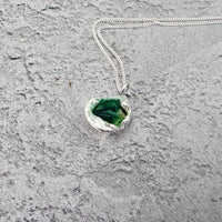 Handmade molten sterling silver pendant with organic texture on an 18-inch chain, photographed on a plain background.