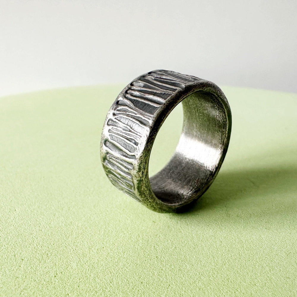 Textured-sterling-silver-Ring-on-green-background