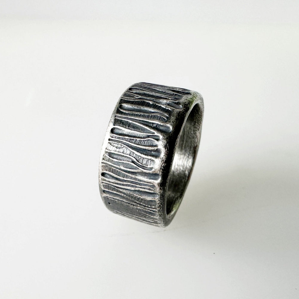 Textured-silver-ring-band-on-a-white-background