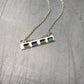 Sterling silver bar necklace with tiny rectangle cells filled with enamel in blue and green
