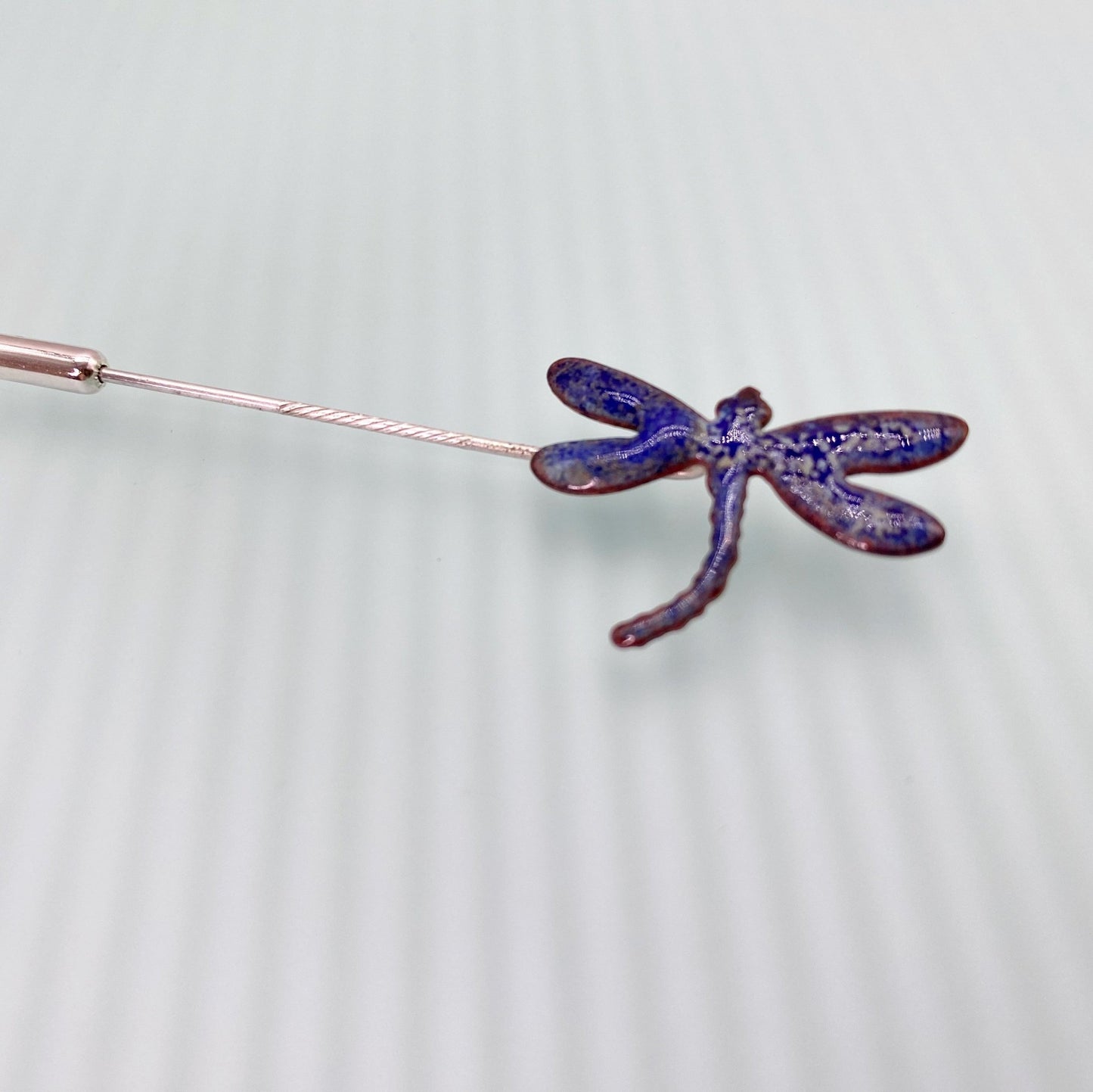 copper dragonfly in blue enamel on a stick pin